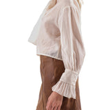 Blusa con fiocco e maniche a sbuffo burro