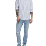 Jeans slim con effetto strappi in denim chiaro