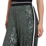 Pantalone stile jogger con paillettes e fascia a contrasto verde